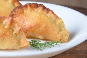 Chebureks - a traditional national dish made from one round dough with meat filling.
