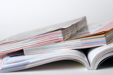 Colorful pages of an open magazine, close up. Selective focus.