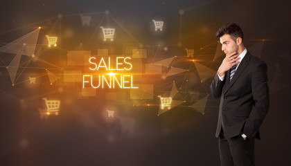 Businessman with shopping cart icons and SALES FUNNEL inscription, online shopping concept