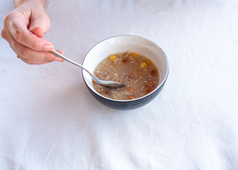 Traditional Turkish dessert ashure or Noah's Pudding with spoon on the table.