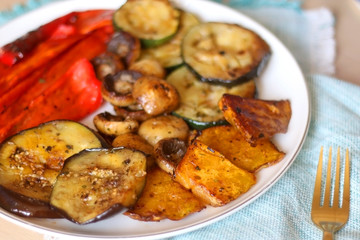 Plate of grilled portobello mushrooms and seasonal vegetables. Selective focus.