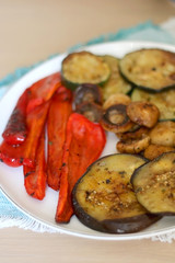 Plate of grilled portobello mushrooms and seasonal vegetables. Selective focus.