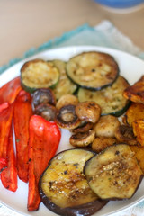 Plate of grilled portobello mushrooms and seasonal vegetables. Selective focus.