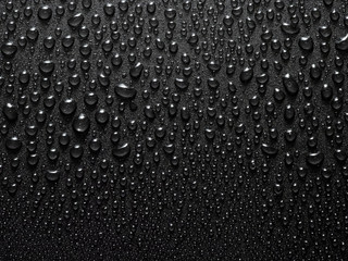 a close-up image of small water drops on a black background. Textured background with water drops. Macro photography