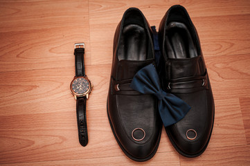 Shoes and wristwatch on the table