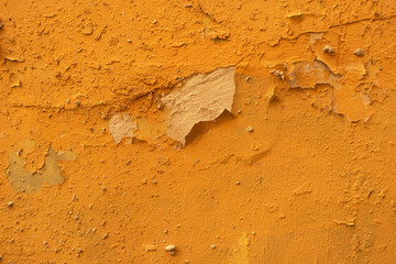 decrepit wall with cracked yellow stucco