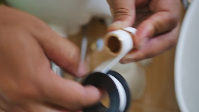The plumber is assembling the water pipes by connecting the water pipes in addition to the existing ones.