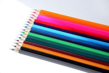 A set of colored pencils on a white background. School supplies.