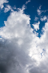 Grey white black big clouds. Sun hidden in the sky.