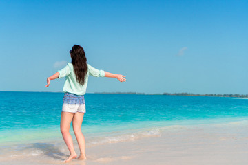 Woman laying on the beach enjoying summer holidays looking at the sea