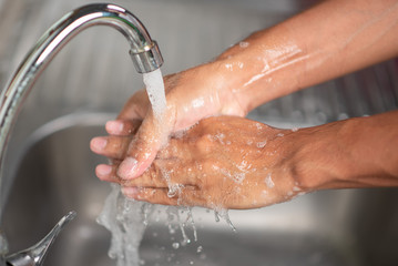 Fototapeta premium Men's hands are showing ways to wash their hands with a cleaning gel to prevent infectious diseases and prevent the virus.