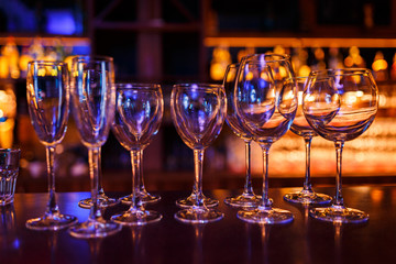 Many wine glasses on the bar with brilliance and light