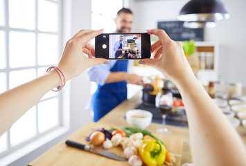 Portrait of handsome man filming cooking show or blog