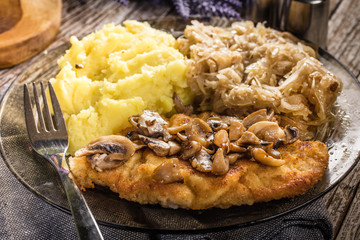 Breaded pork chop with mushrooms.