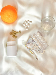 Fototapeta na wymiar Illness, treatment with pills and oranges 