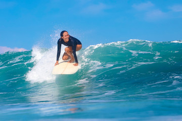 Female surfer on a blue wave - 331709544