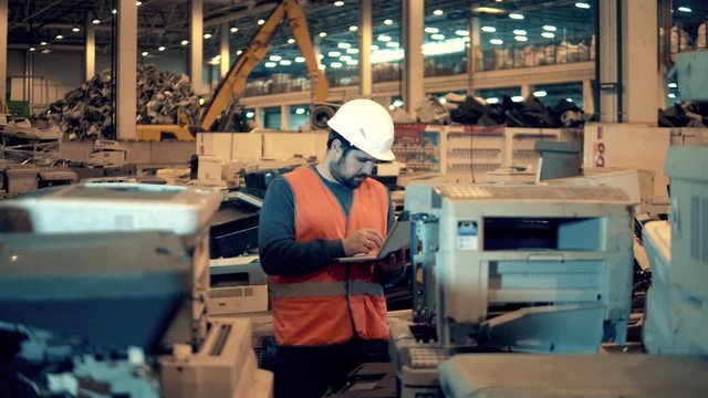 Male employee is examining defective office machines