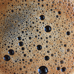 Thick coffee foam closeup top view