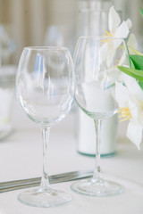  Light decor in the style of fine art. Glasses and tulips in the composition. Wedding table decor with white Studio.