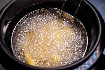 French fries. oil boiling in a deep fryer at home.