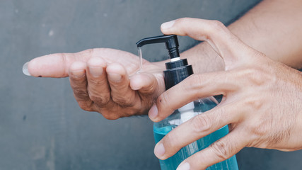 Female hands using wash hand sanitizer gel 