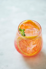 Pink grapefruit juice with mint leaves 