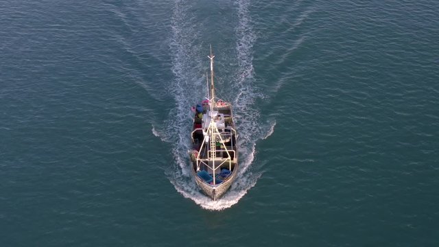 Fishing Boat in the Early Morning Heading Out to Sea
