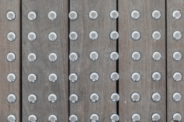The texture of the floorboards with iron rivets