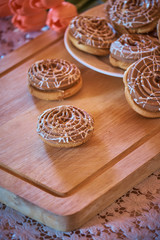 Cookies and coffee on a wooden board