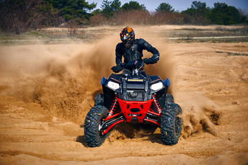 Racing in the sand on a four-wheel drive quad.