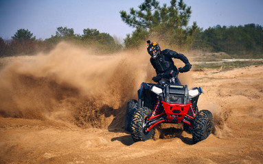 Racing in the sand on a four-wheel drive quad.