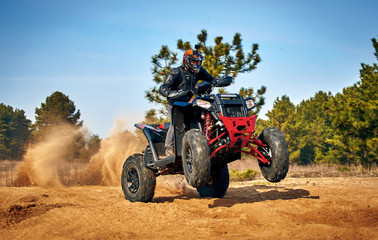 Racing in the sand on a four-wheel drive quad. © Bondariev Volodymyr.