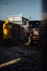 Man in protective suit disinfect a car after during the new coronavirus Covid-19.	