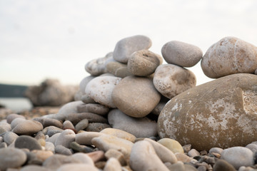 Fototapeta na wymiar Abstract composition of pebbles stacked on top of each other on the shore