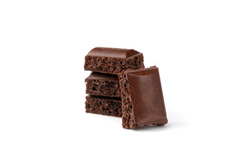 Porous dark chocolate isolated on white background.