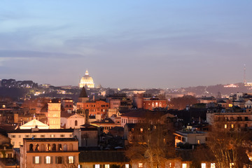 Fototapeta na wymiar Night longexposure shot of the magnificent city of Rome seen at sunset time from a garden on the hills, some famous monuments are visible 