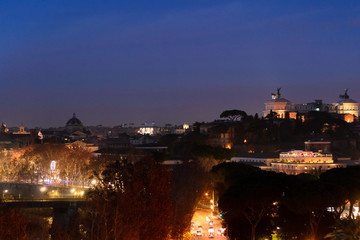 Night longexposure shot of the magnificent city of Rome seen at sunset time from a garden on the hills, some famous monuments are visible 