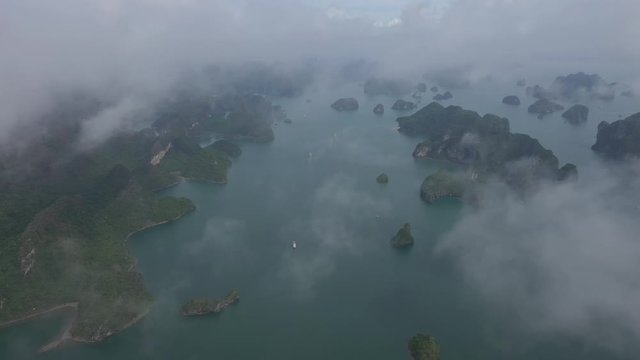 Aerial view of royalty high quality free stock footage over natural rocks green tops Halong bay, Ba Hang floating fishing village, sea blue azure water. Wild natural untouched seascape. Asia, Vietnam