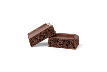Porous dark chocolate isolated on white background.