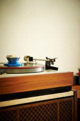 Record player, white wall background 