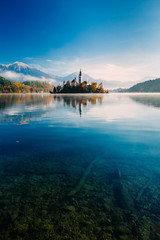 Amazing view on a misty morning of lake Bled with St. Marys Church of the Assumption on the small island; Bled, Slovenia, Europe. - 331717982