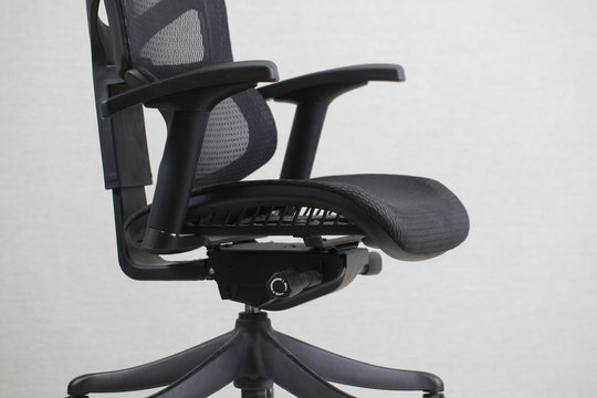 Old dirty office ergonomic chair with mesh coating.