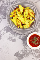 fried potatoes on a plate with tomato sauce