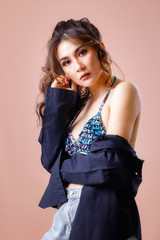 Asia beautiful woman wear swimsuit with pink background in studio. Summer concept.