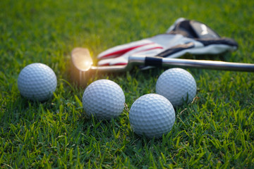 Golf equipment on green grass.