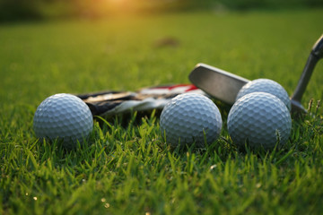 Golf equipment on green grass.