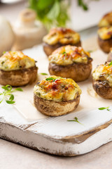 Stuffed mushrooms with cheese, delicious baked appetizer, traditional starter, golden crust.