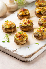 Stuffed mushrooms with cheese, delicious baked appetizer, traditional starter, golden crust.