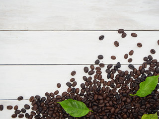 Roasted coffee beans with coffee leaves.