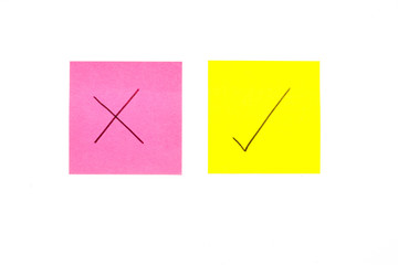 Three post its on white background with a question mark and tick